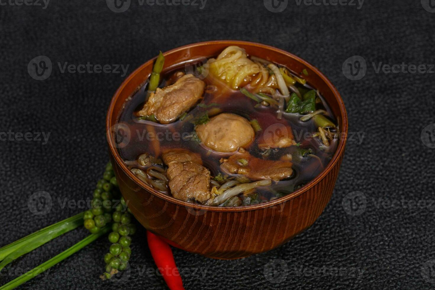 Thai style soup with meat and mushrooms photo
