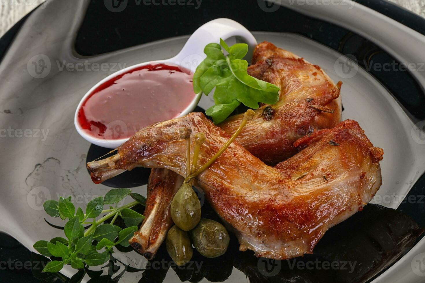 Roasted rabbit legs photo