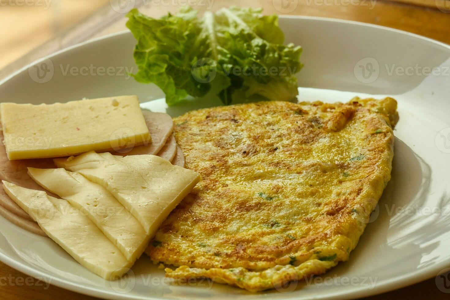 Omelet with cheese and salad photo