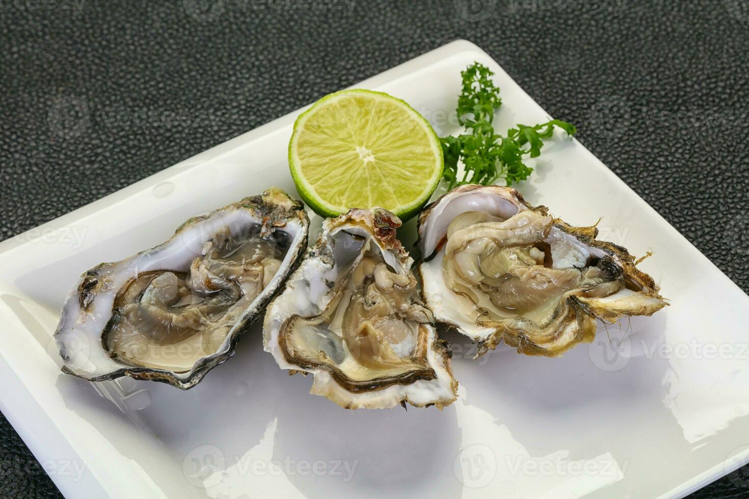 Oysters with lime and parsley photo