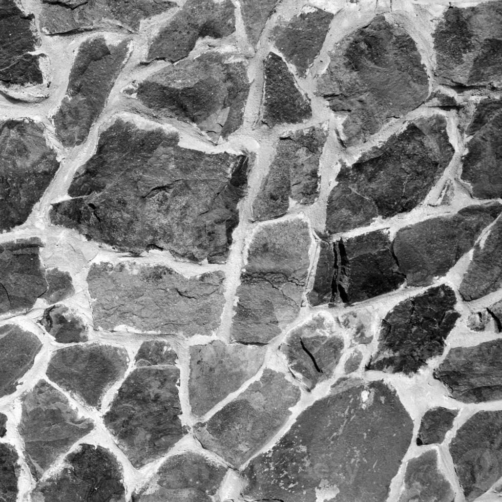 sin costura Roca modelo. antiguo Roca pared negro y blanco monocromo textura foto