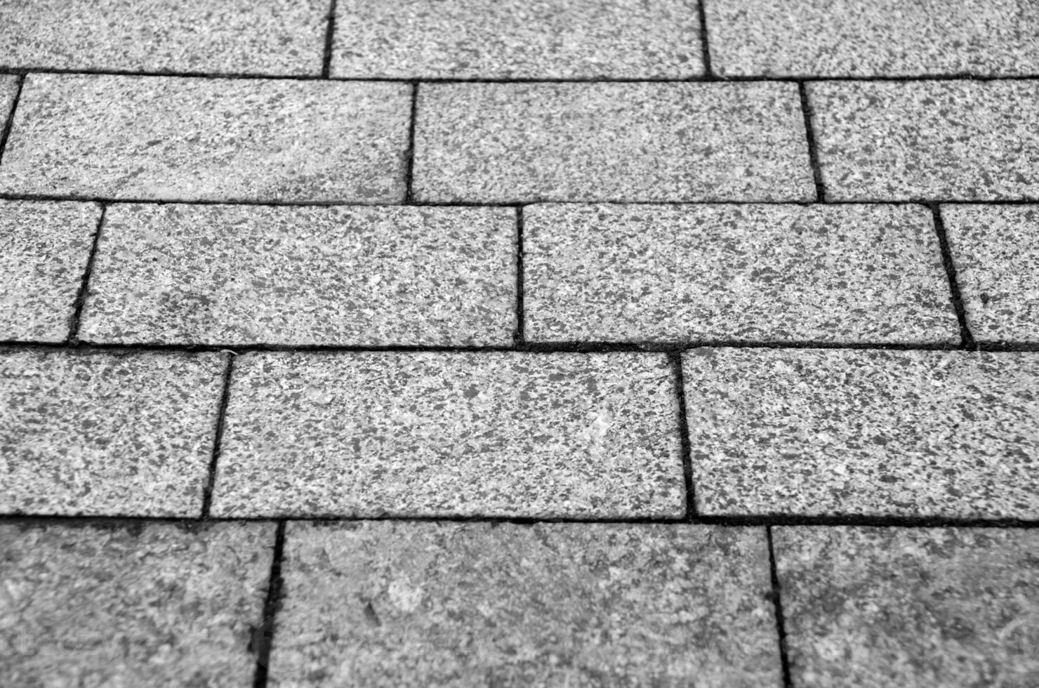 Road stone pavement texture, grey bricks black and white pattern photo
