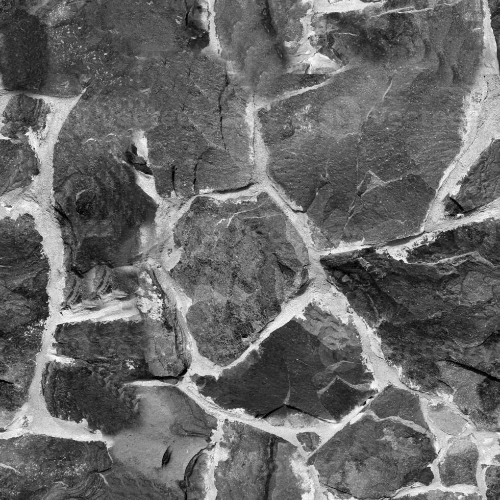 Seamless stone pattern. Old stone wall black and white monochrome texture photo