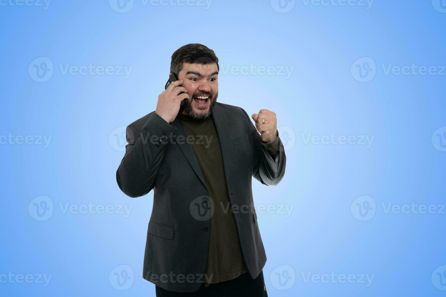 Happy Man Standing Outdoors, Using Phone and Shouting Under Blue Sky photo