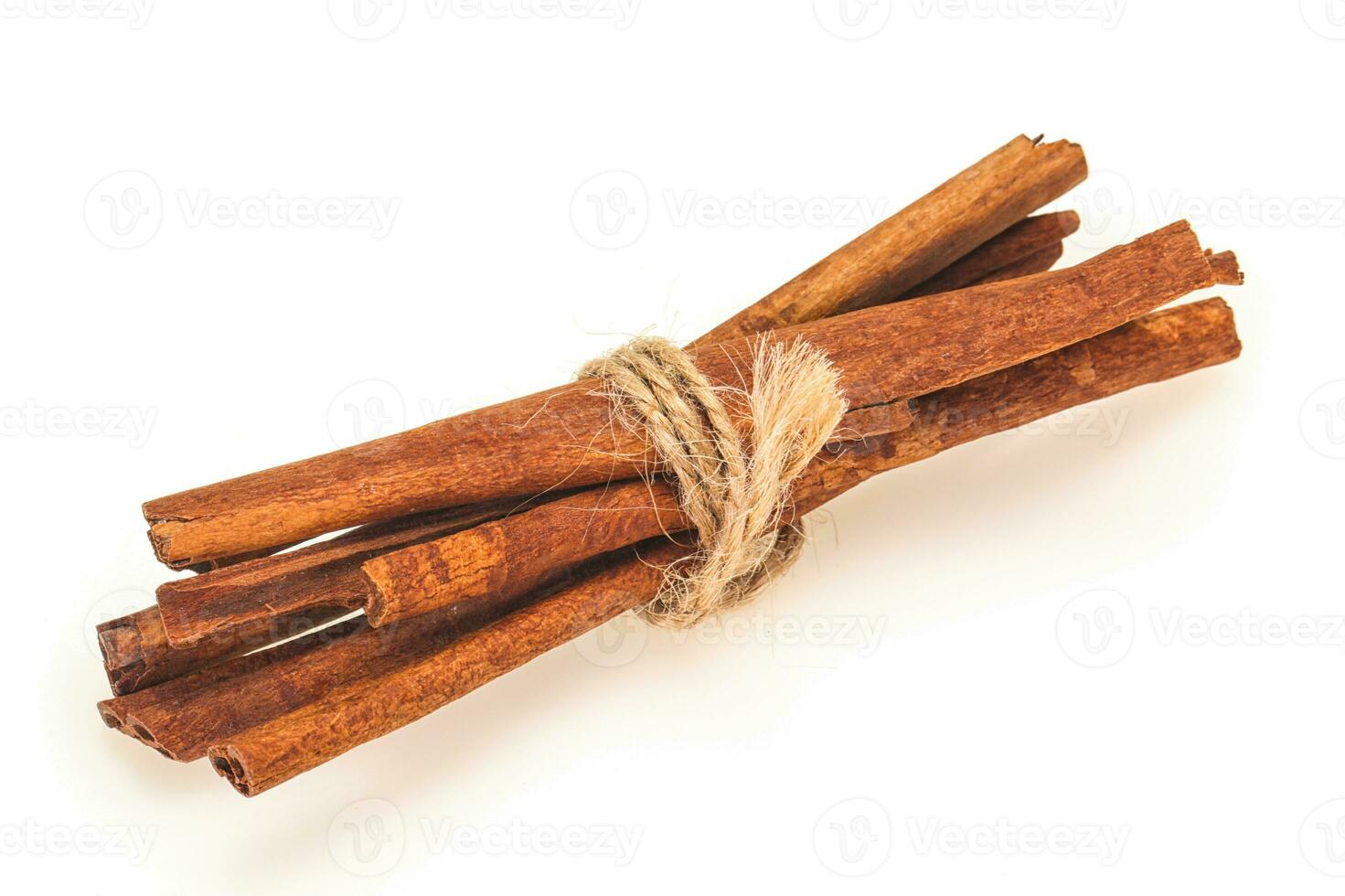 Cinnamon sticks heap isolated on white photo