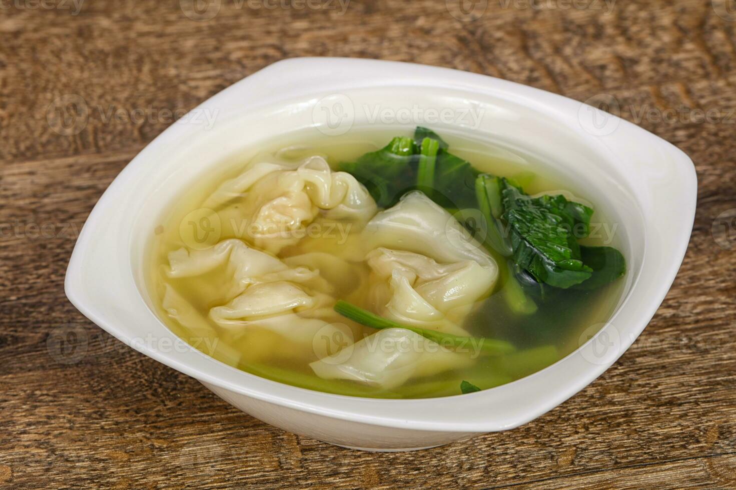 Asian traditional Wonton soup with herbs photo