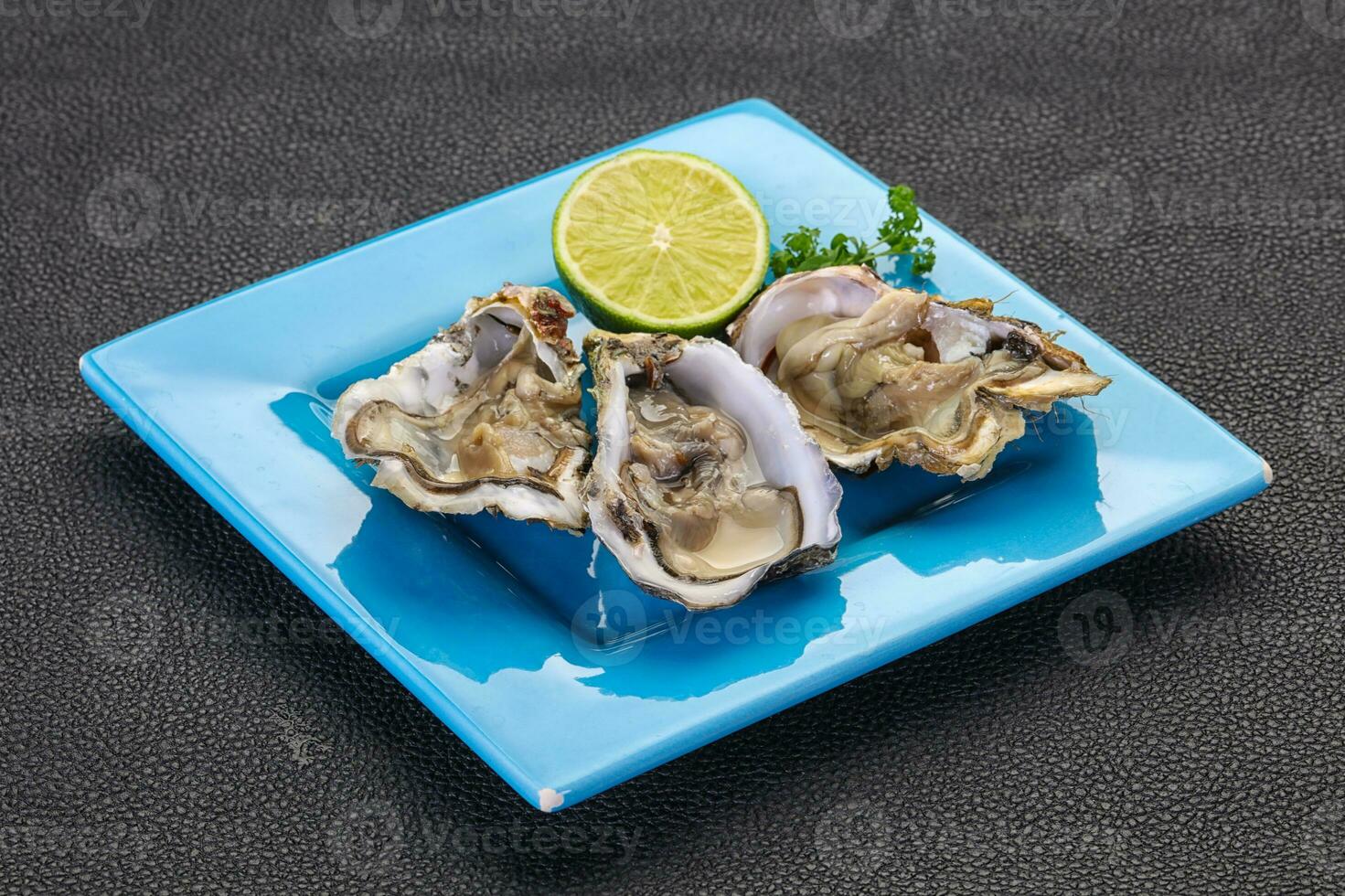 Oysters with lime and parsley photo