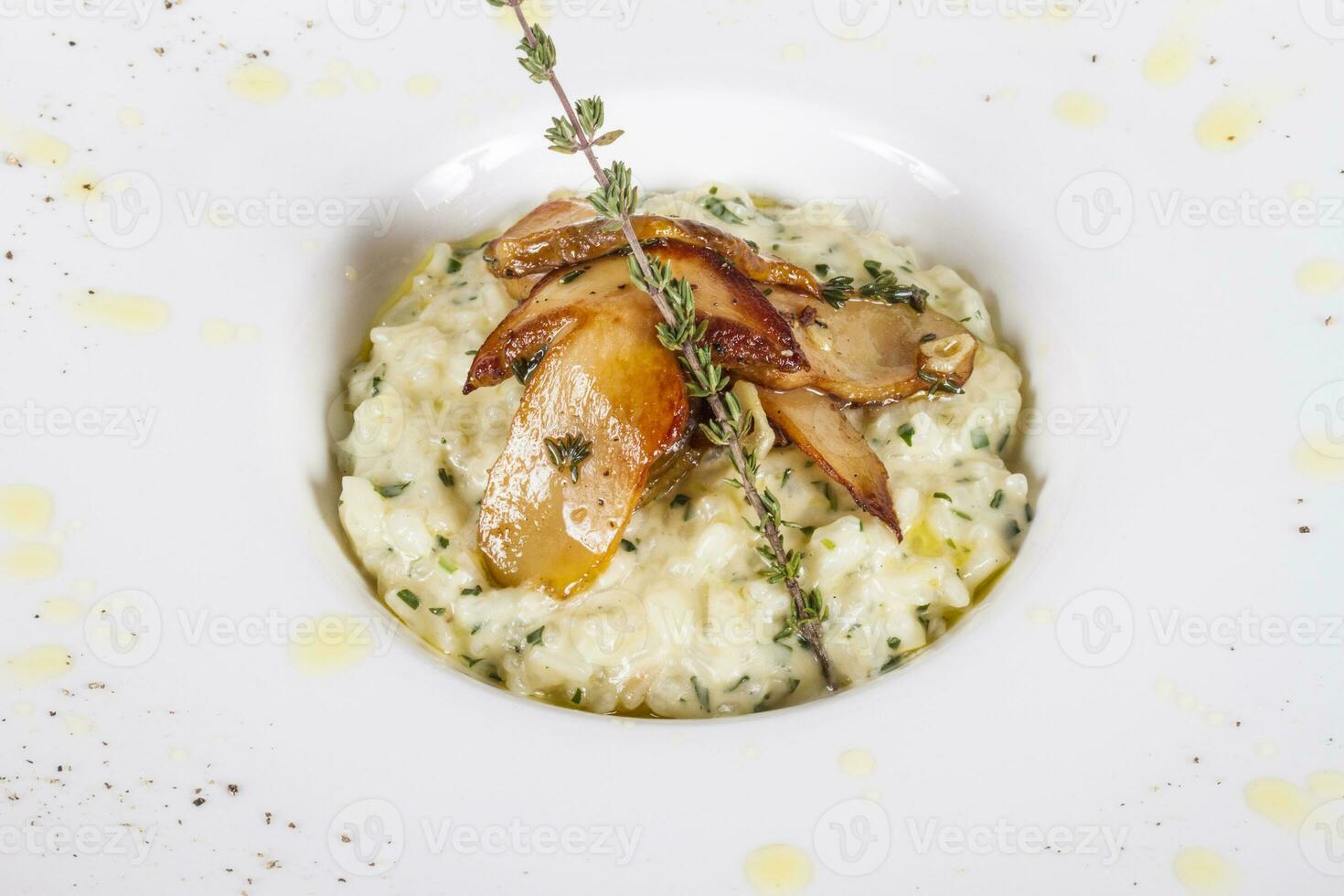 photo of delicious risotto dish with herbs and mushrooms on white background