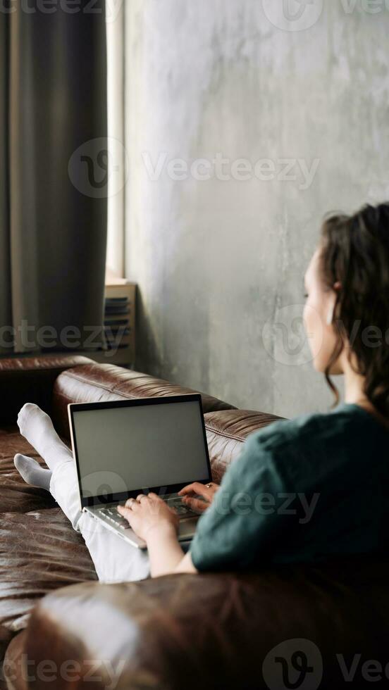 Digital Connectivity and Productivity. Young Woman Utilizes Laptop with Blank White Screen at Home. Explore the Versatility of Freelancing, Student Lifestyle, Education, Web Conferencing, Video Calls, photo