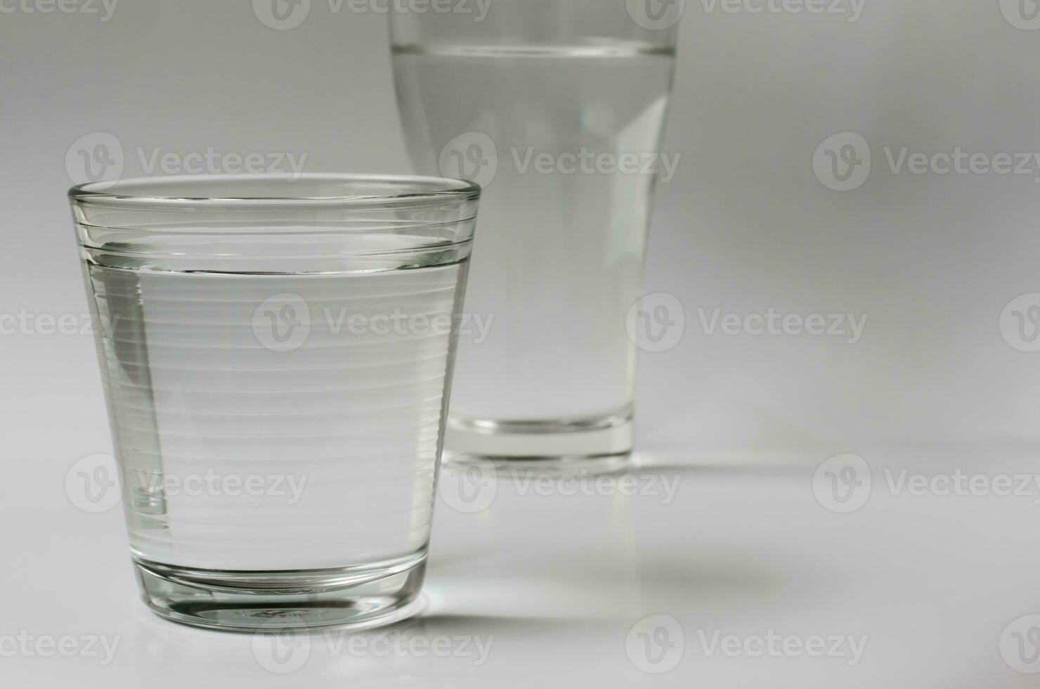 Glass of Drinking Water on Clear Background for Copy Space photo