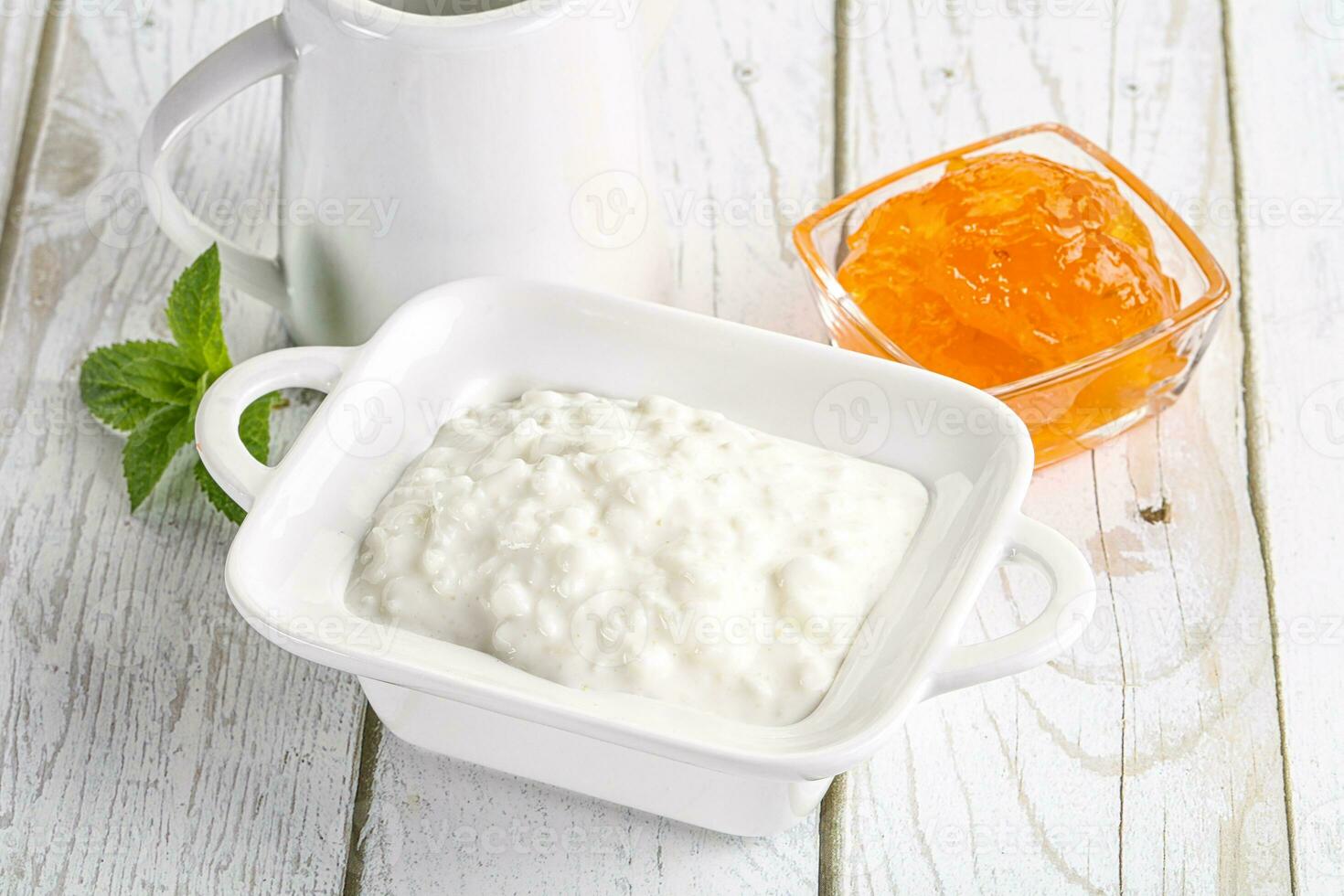 Grain curd with cream and jam photo