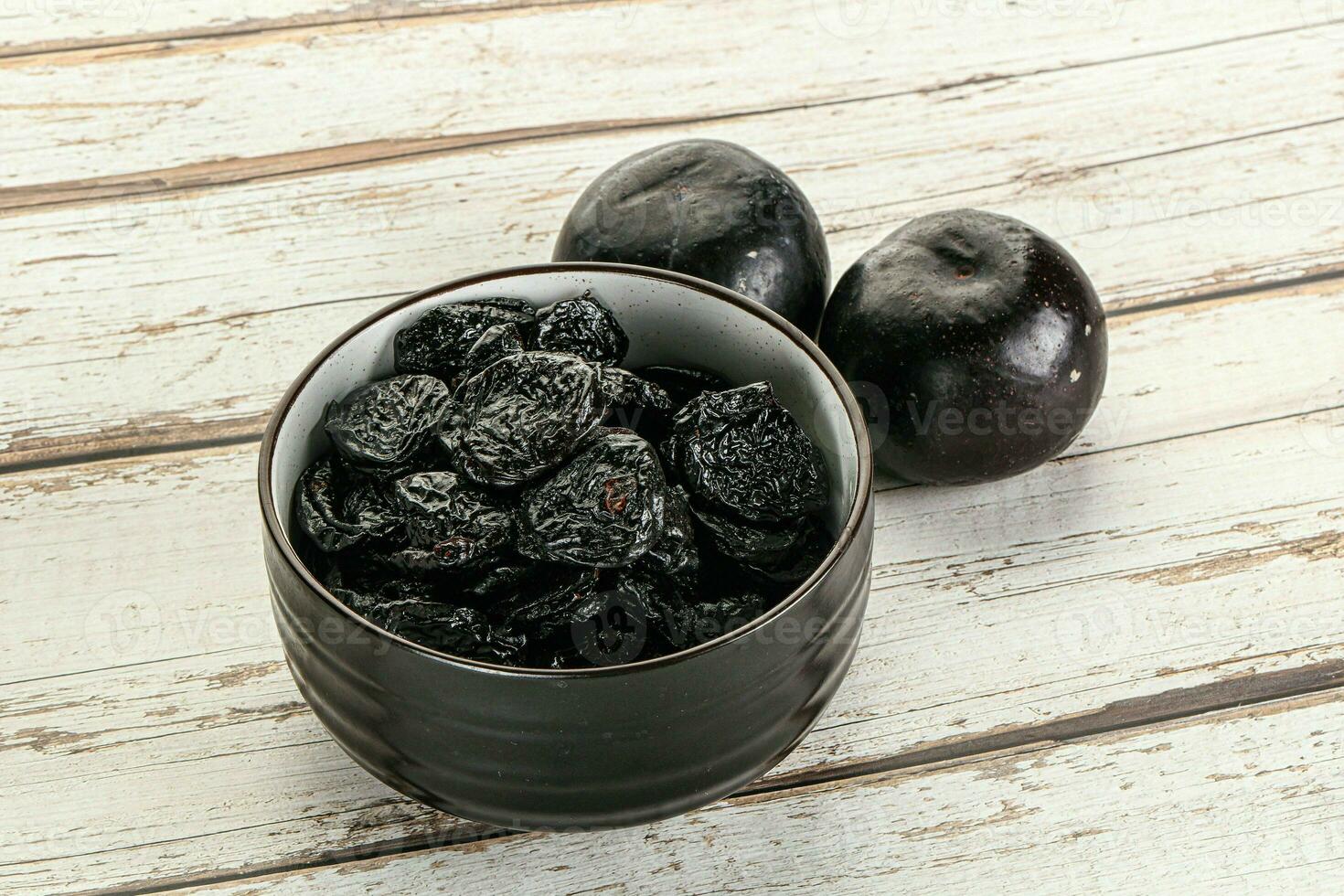 Dry prunes in thw bowl photo