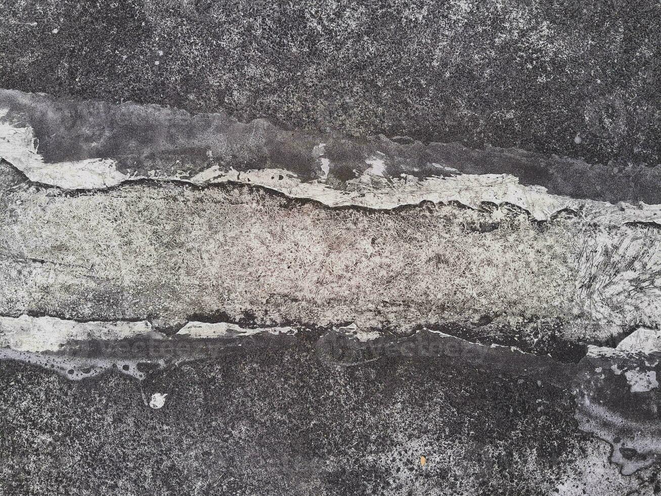 Grungy wall of gray concrete texture with cracked surface from sand and cement materials. photo