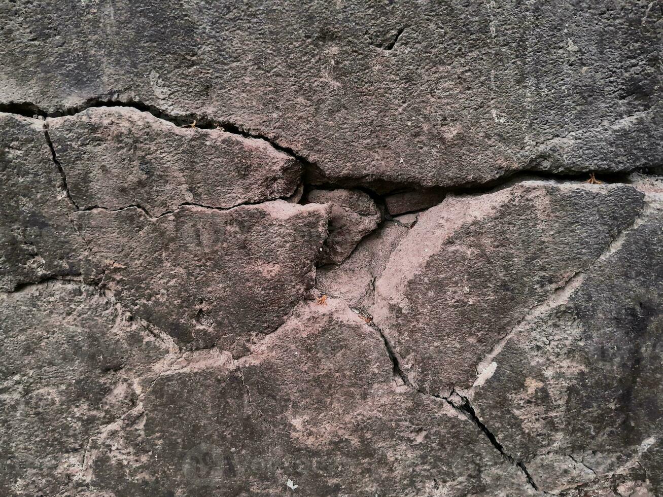 Grungy wall of gray concrete texture with cracked surface from sand and cement materials. photo