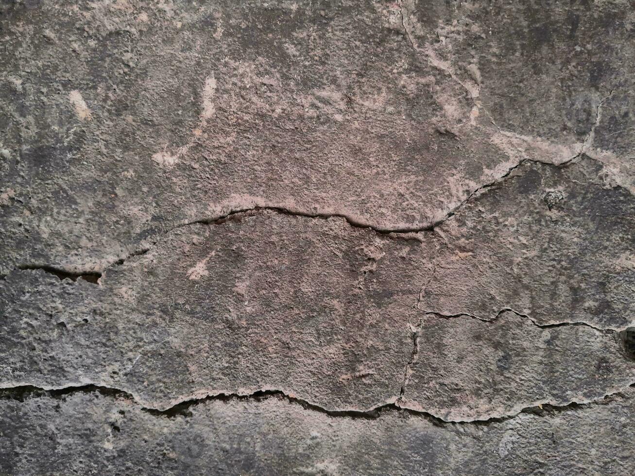 Grungy wall of gray concrete texture with cracked surface from sand and cement materials. photo