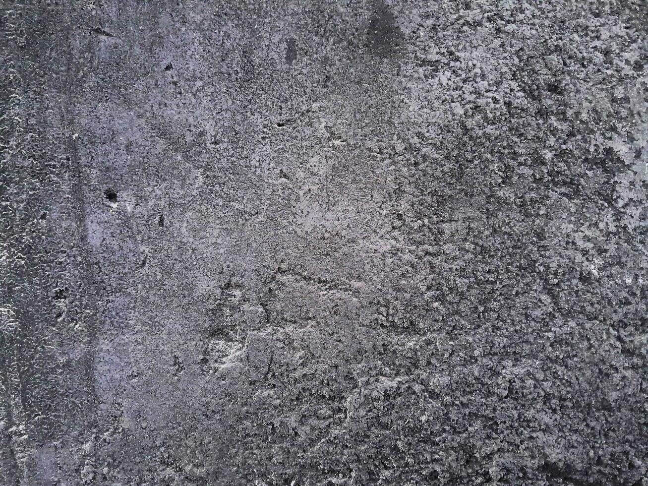 Grungy wall of gray concrete texture with cracked surface from sand and cement materials. photo