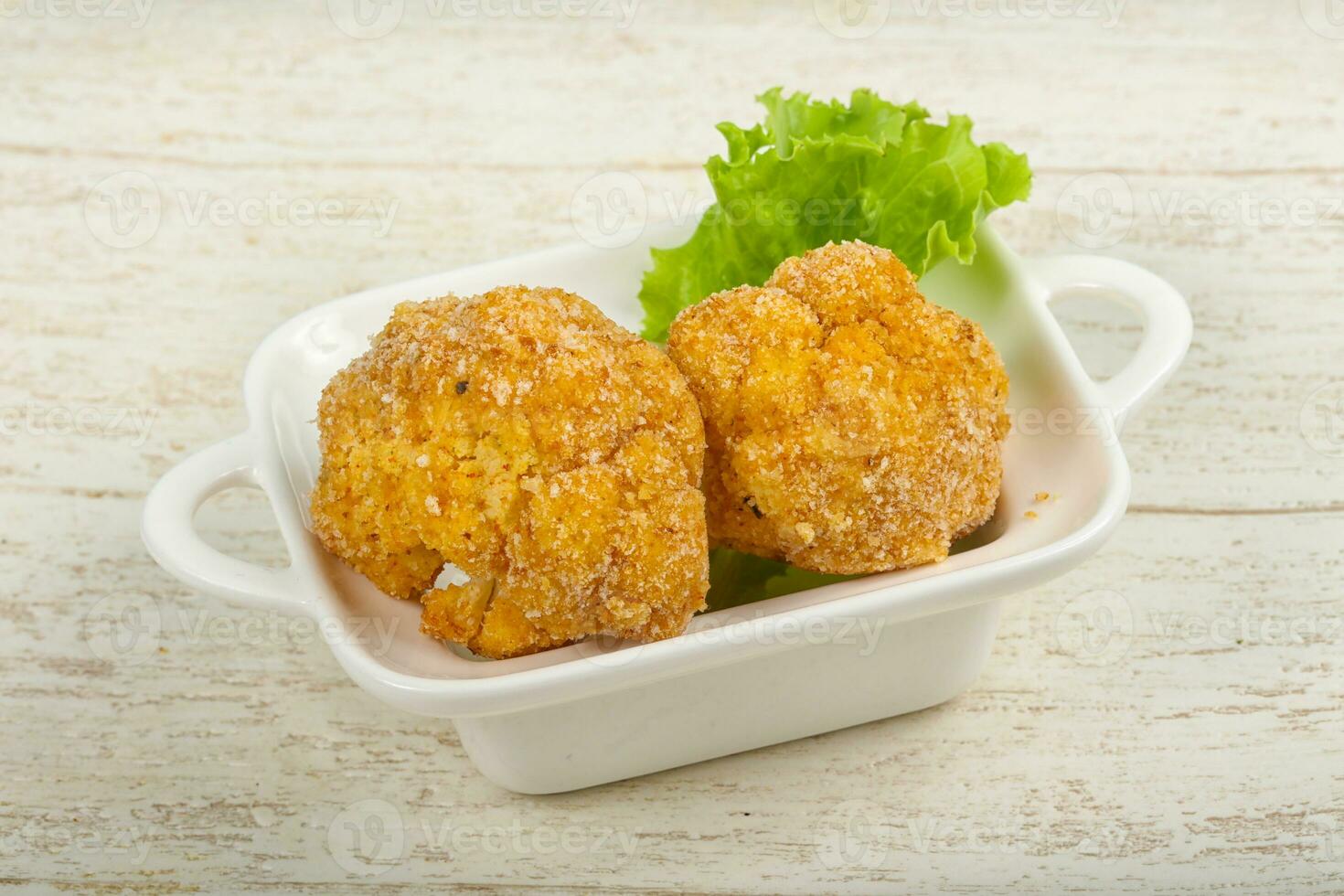 Crispy cauliflower over wooden background photo