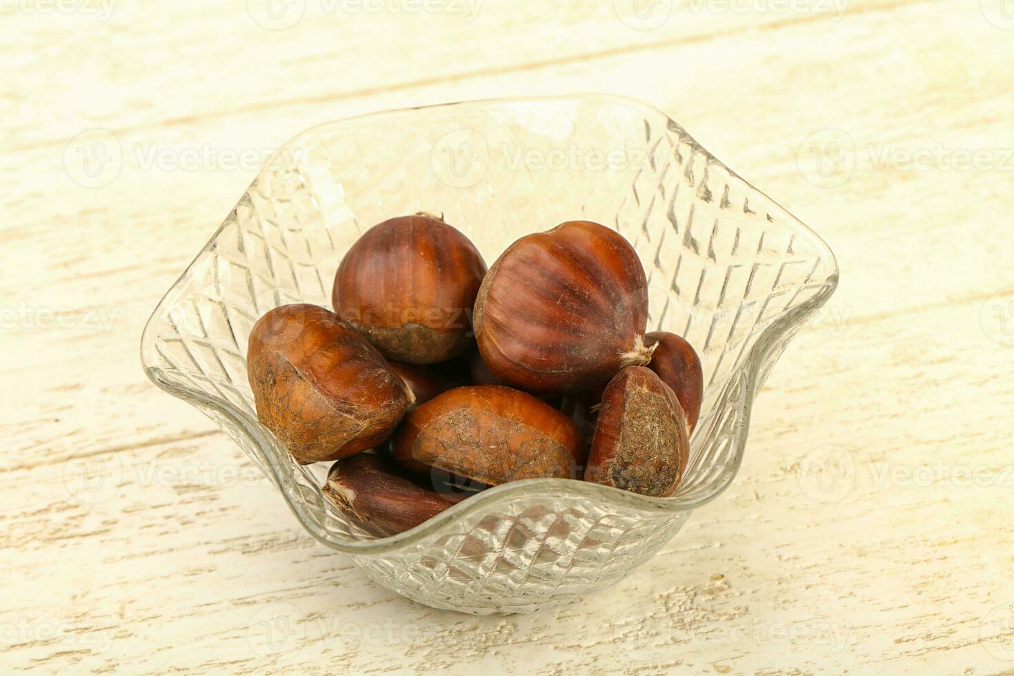 Chestnut over wooden background photo