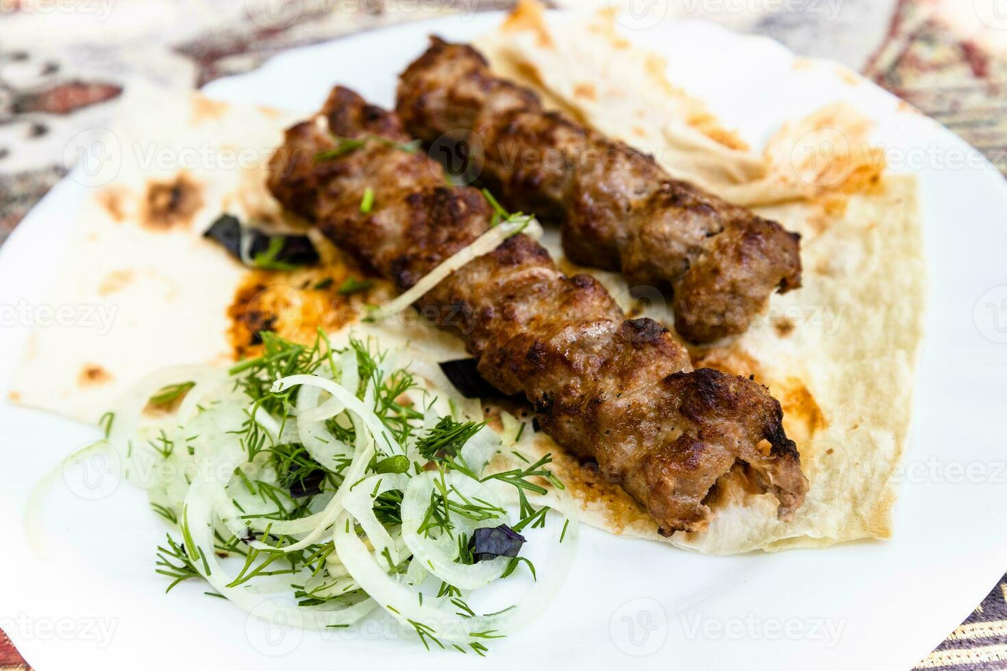 portion of Armenian kebabs on plate close up photo