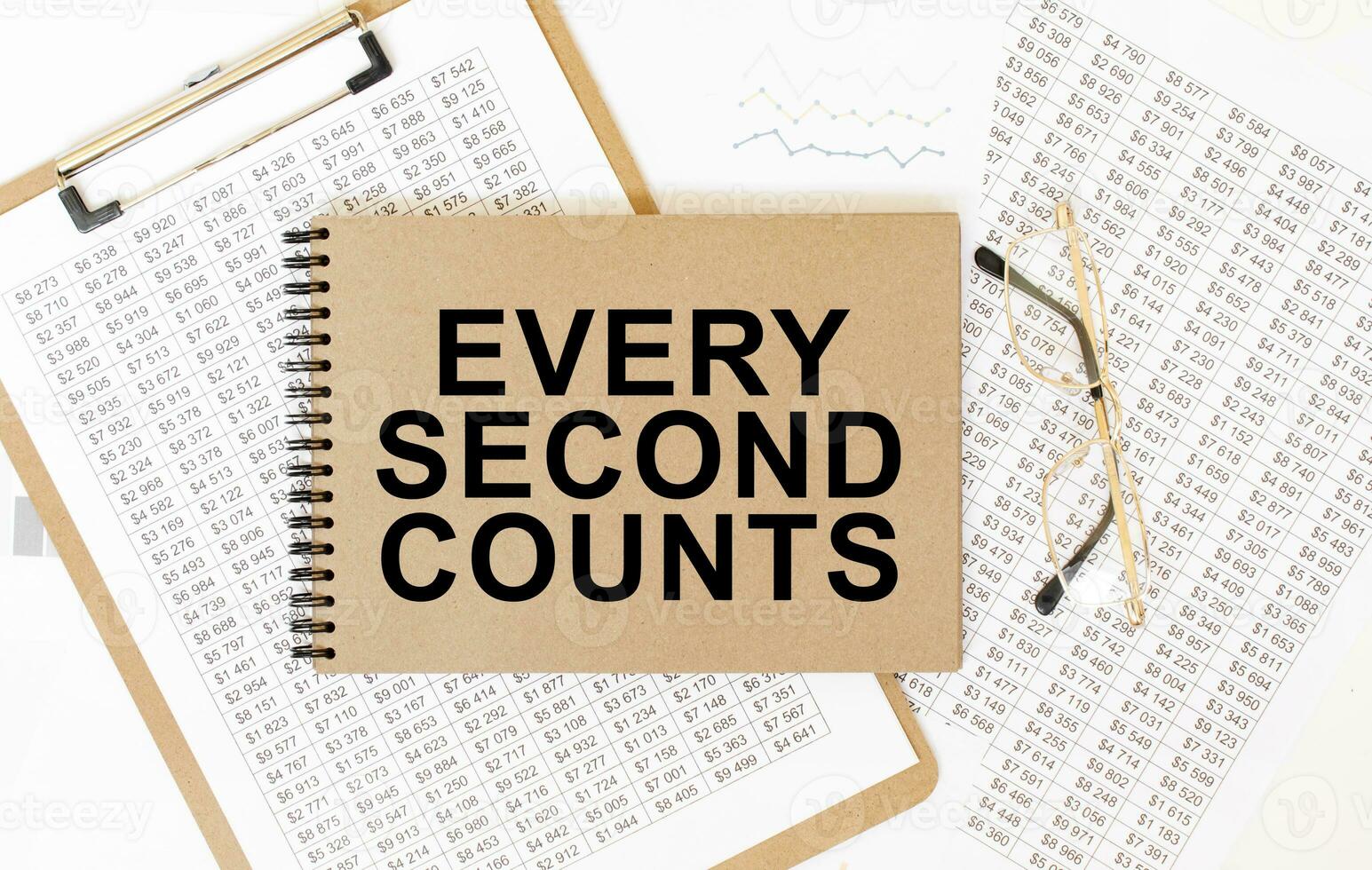 Craft colour notepad with text EVERY SECOND COUNTS. Notepad with eyeglasses and text documents. Business concept photo