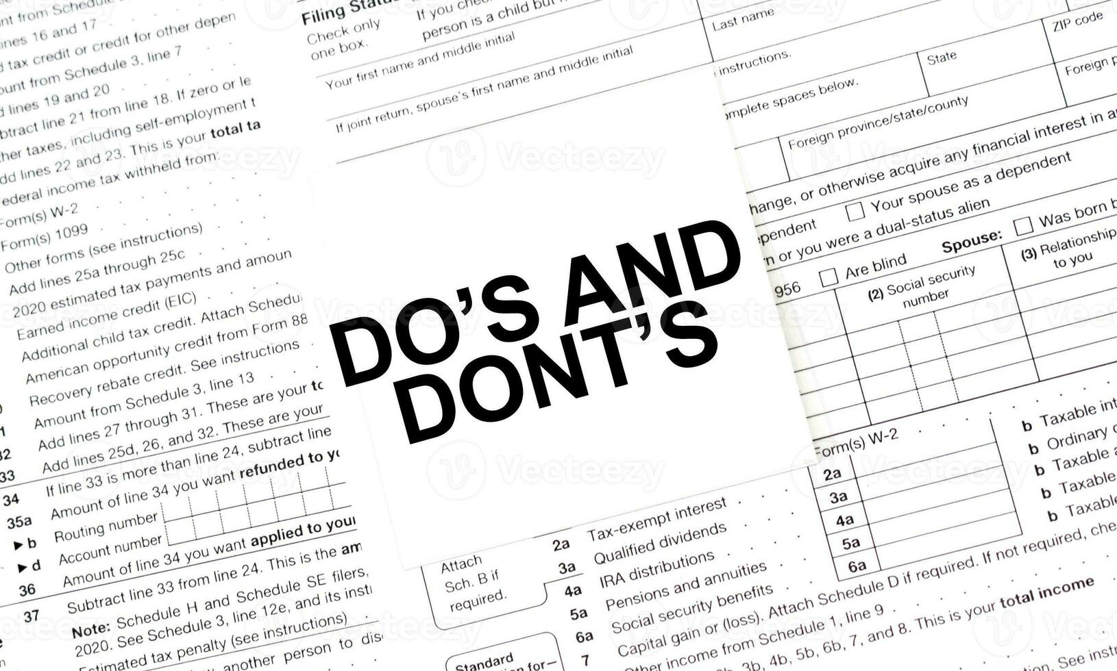 DO's and DONT's on white sticker with tax forms photo