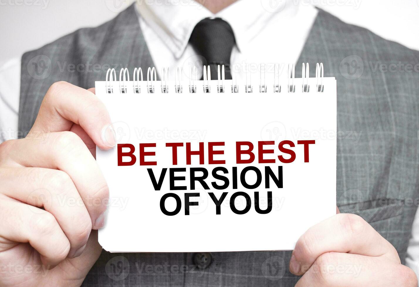 Businessman with notebook with text BE THE BEST VERSION OF YOU photo