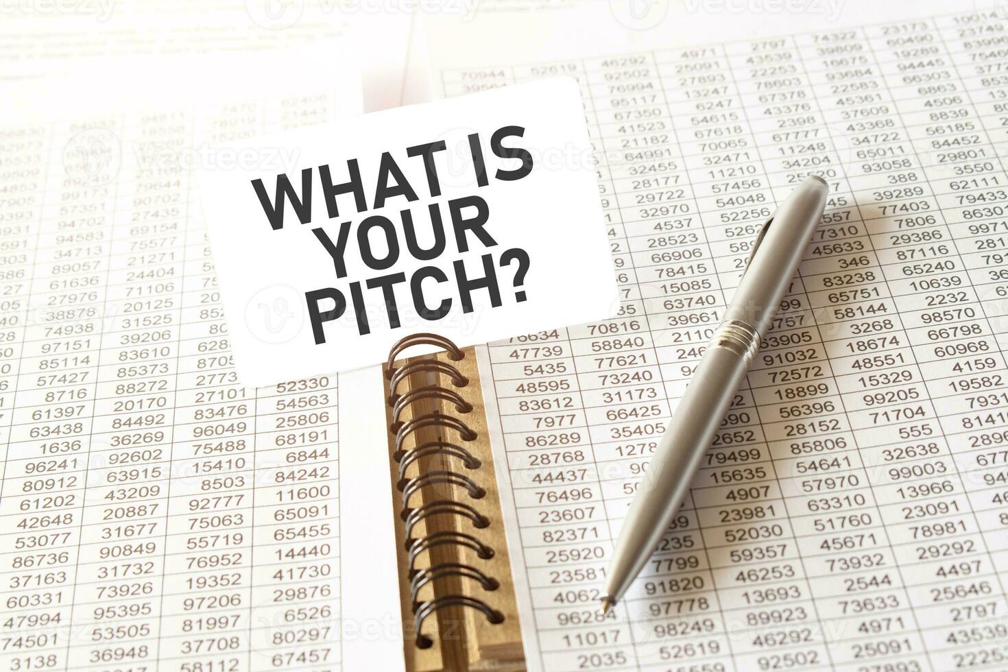 Text WHAT IS YOUR PITCH on paper card, pen, financial documentation on table photo