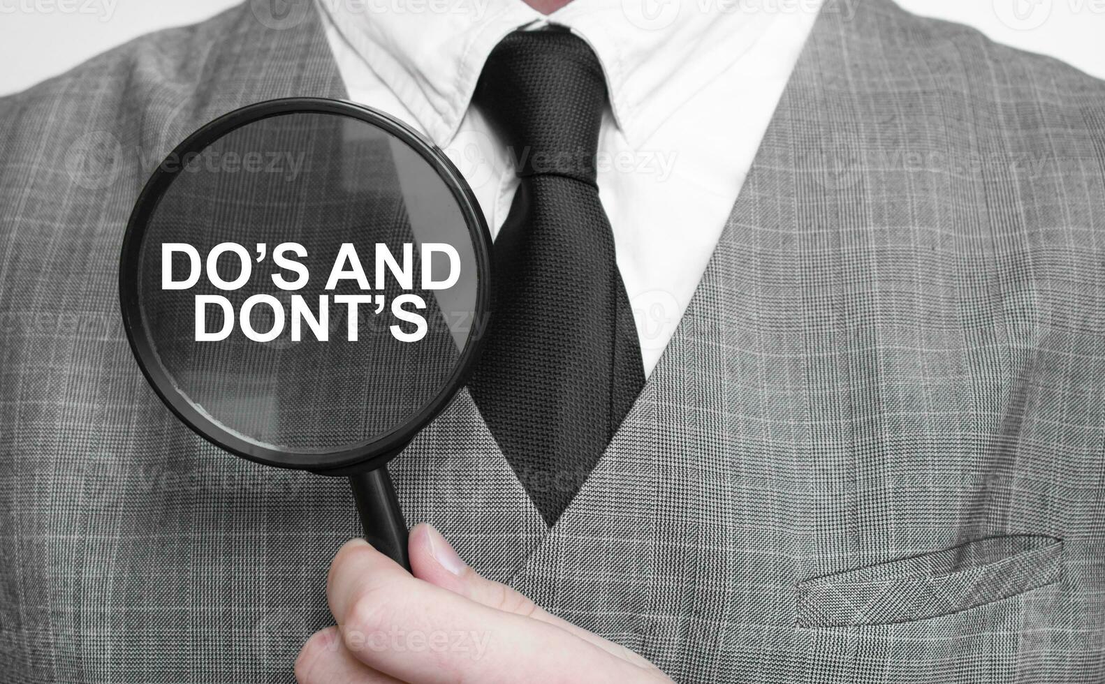 DO's and DONT's on magnifying glass and businessman photo