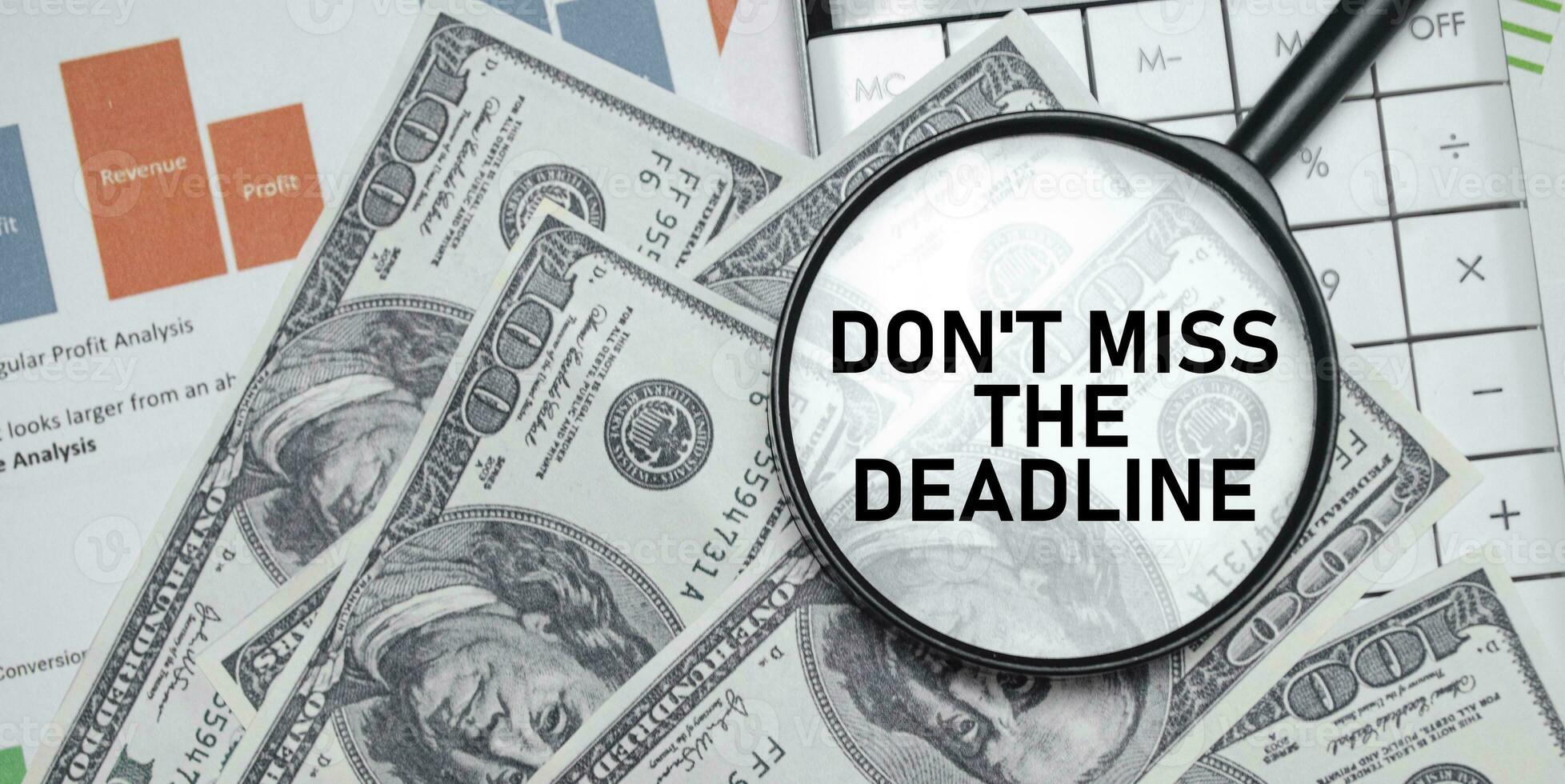 don't miss the deadline word on magnifying glass with dollars and charts photo