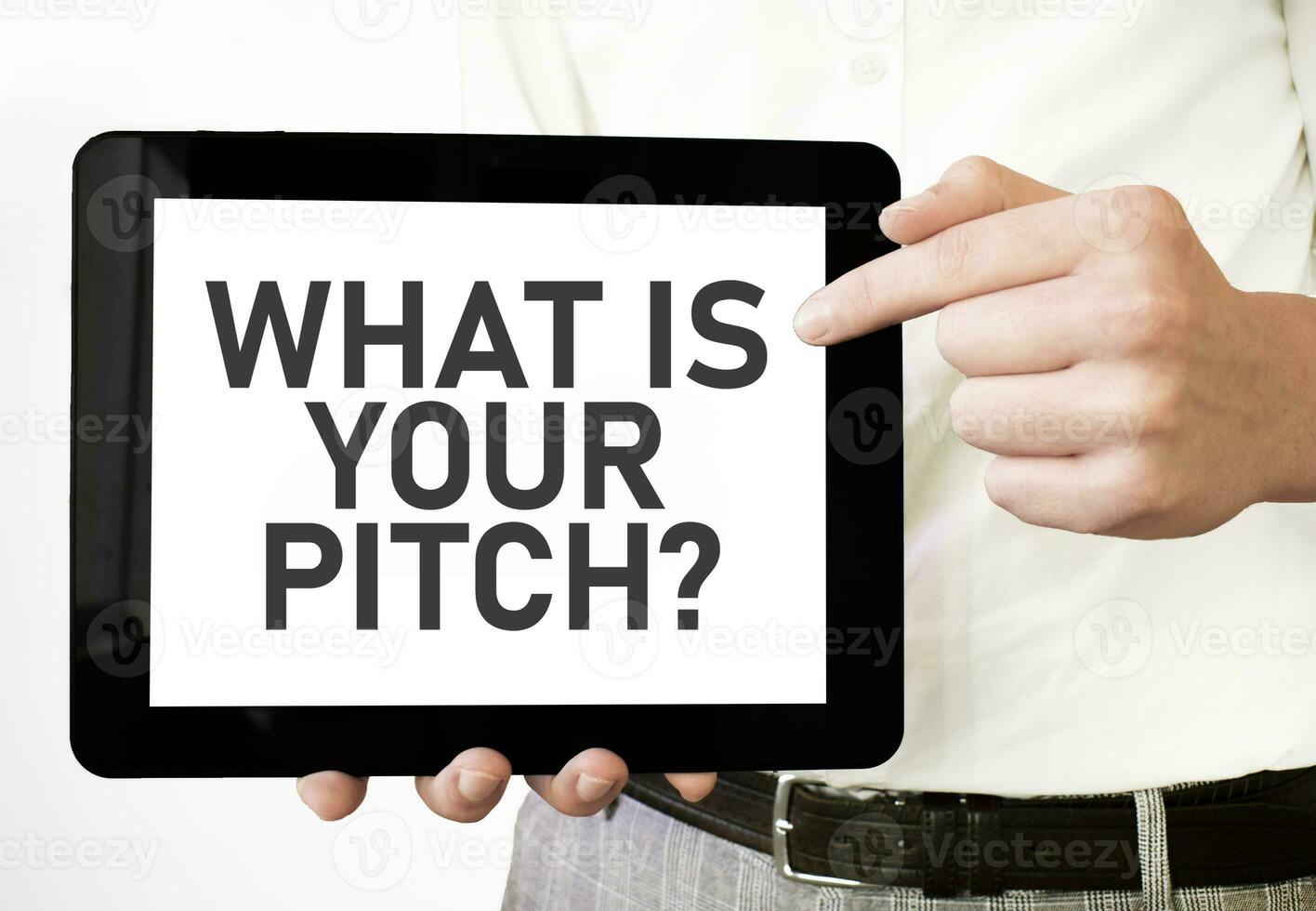 Text WHAT IS YOUR PITCH on tablet display in businessman hands on the white background. Business concept photo