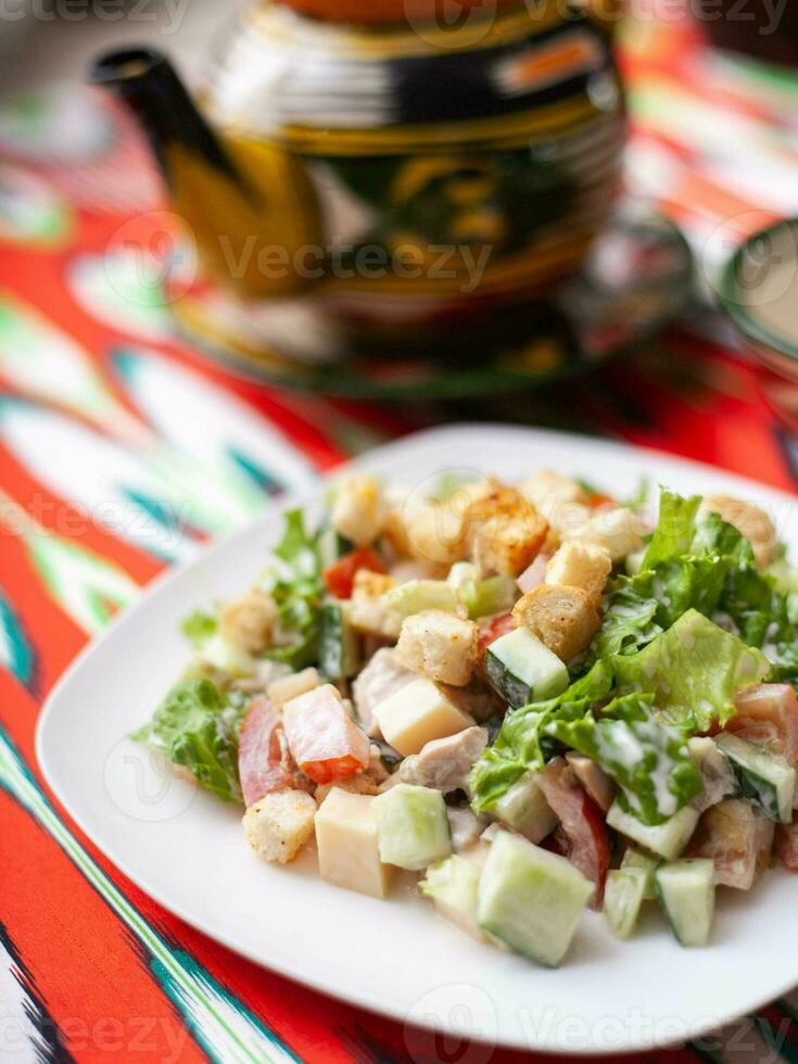 Tomato, cucumber, sweet pepper and onion salad, seasoned with oil. Asian style photo