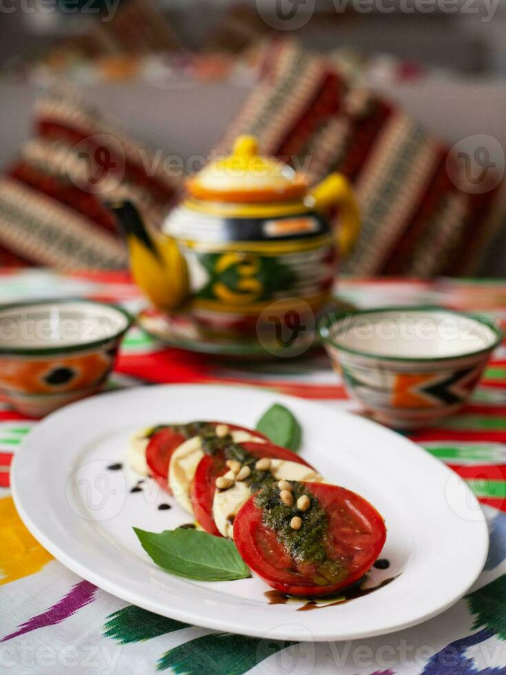 Italian caprese salad with tomatoes, mazzarella cheese and balsamic sauce. Asian style photo