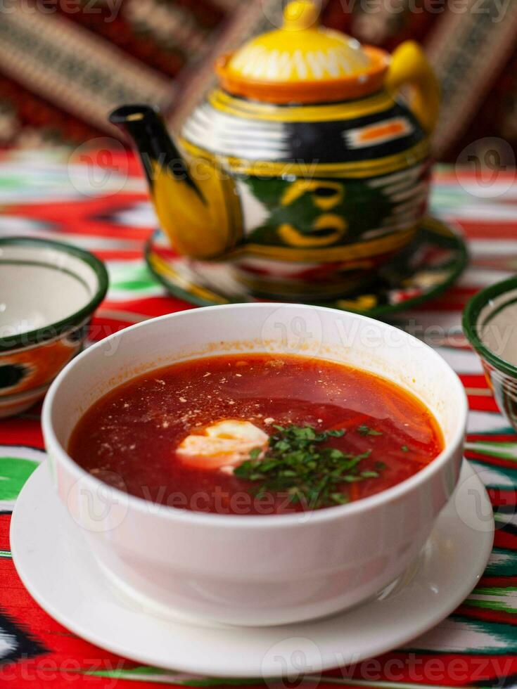 Borscht. Russian soup made from meat, beets, potatoes and served with sour cream. Asian style photo