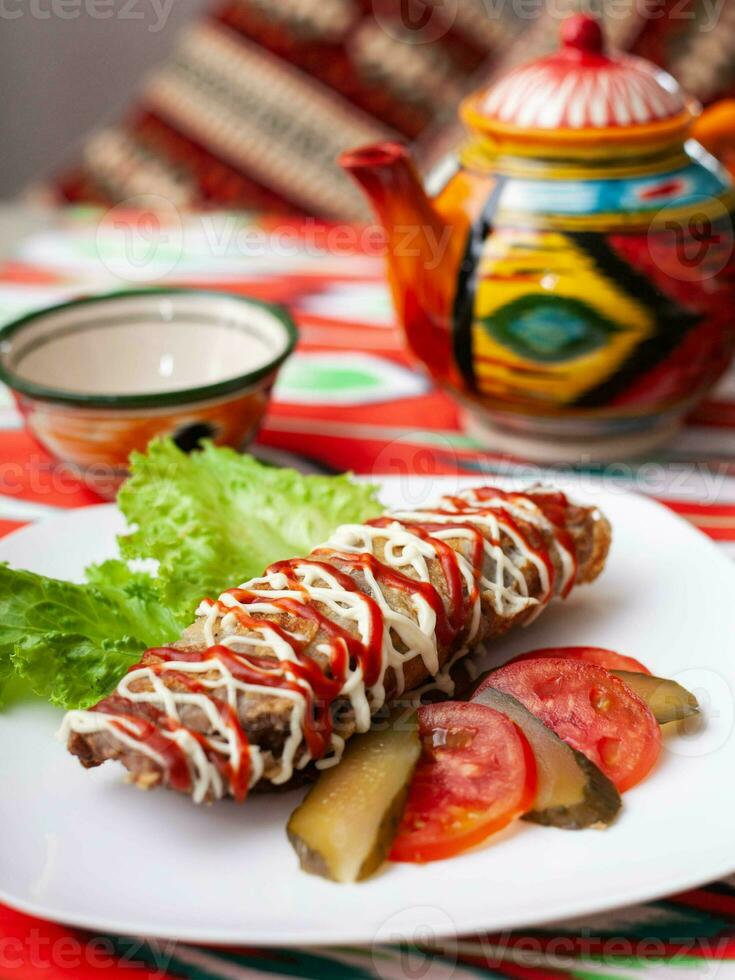 Brizol a dish of omelet and beef covered with ketchup and mayonnaise in an oriental style photo