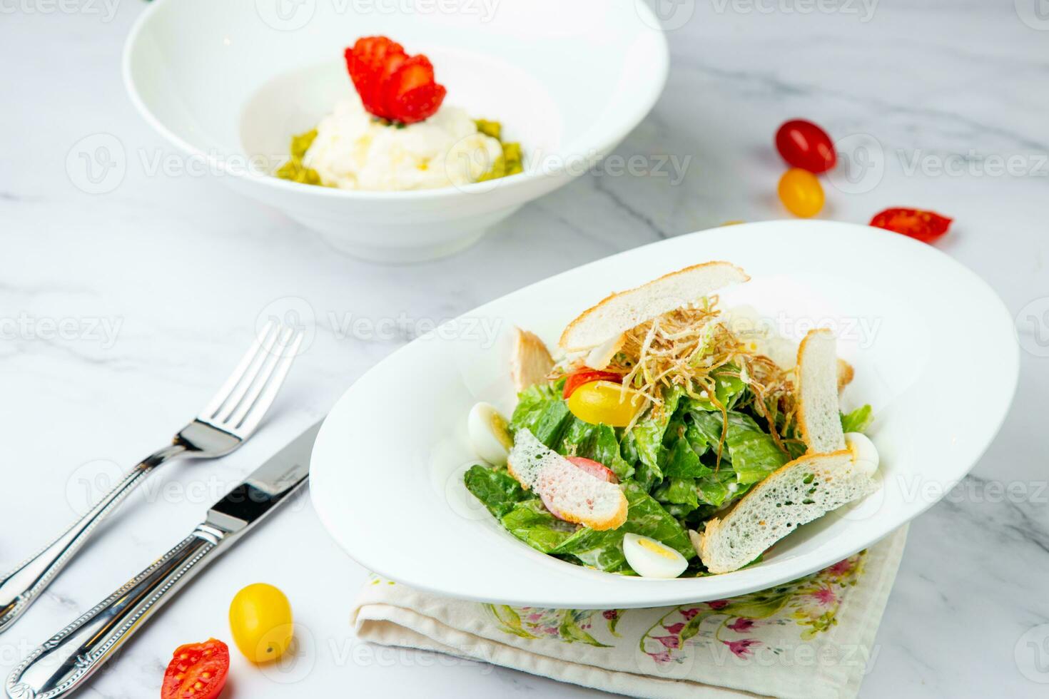 salad with quail eggs, cherry tomatoes, lettuce and breadcrumbs, side view photo