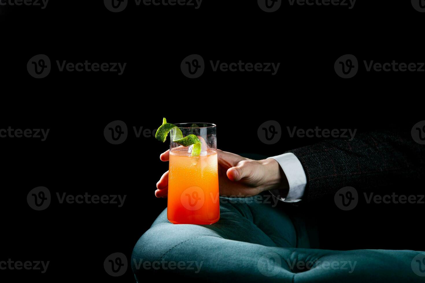 tropical cocktail with sunset gradient and citrus side view photo