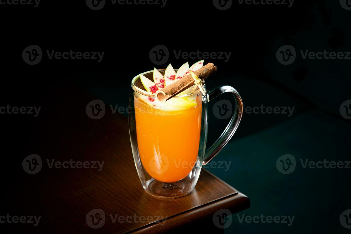 tropical orange cocktail with cinnamon side view photo