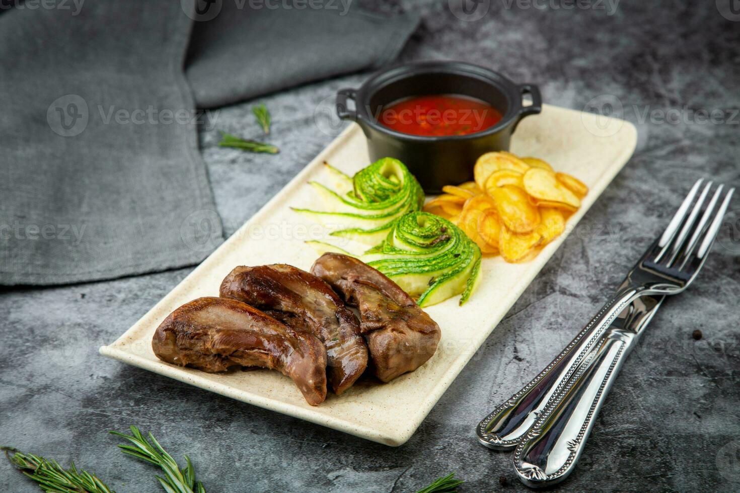 beef meat with chips, cucumbers and barbecue sauce, side view photo