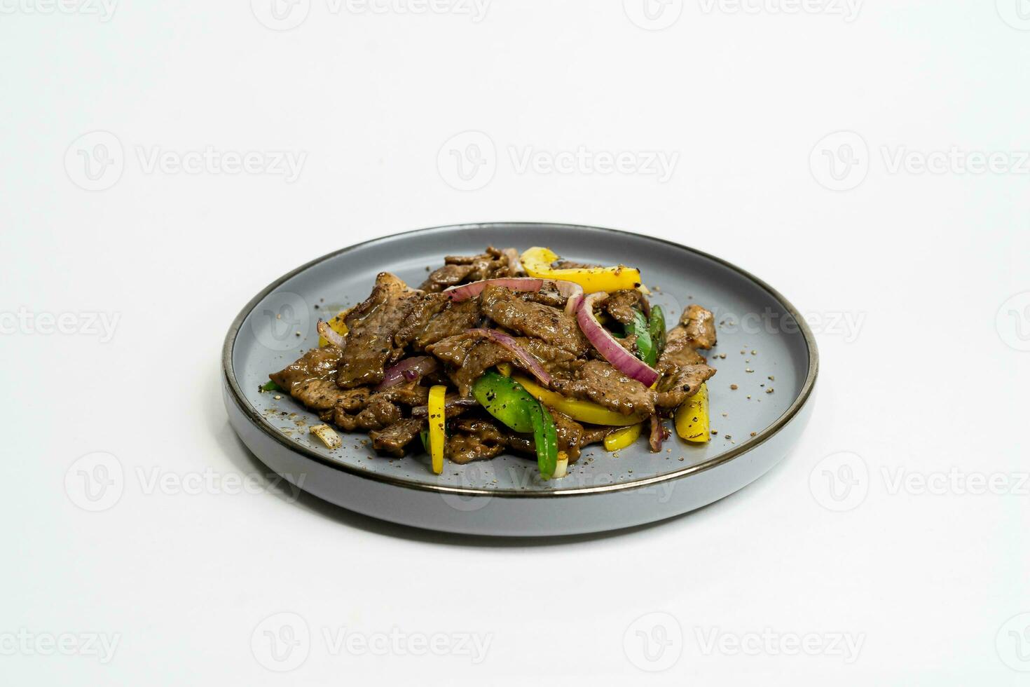 black pepper beef with vegetables on a plate photo