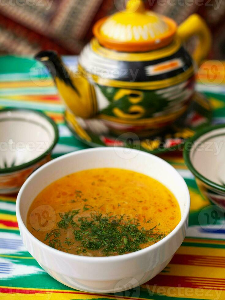 Red tomato soup with herbs, potatoes and meat. Eastern cuisine photo