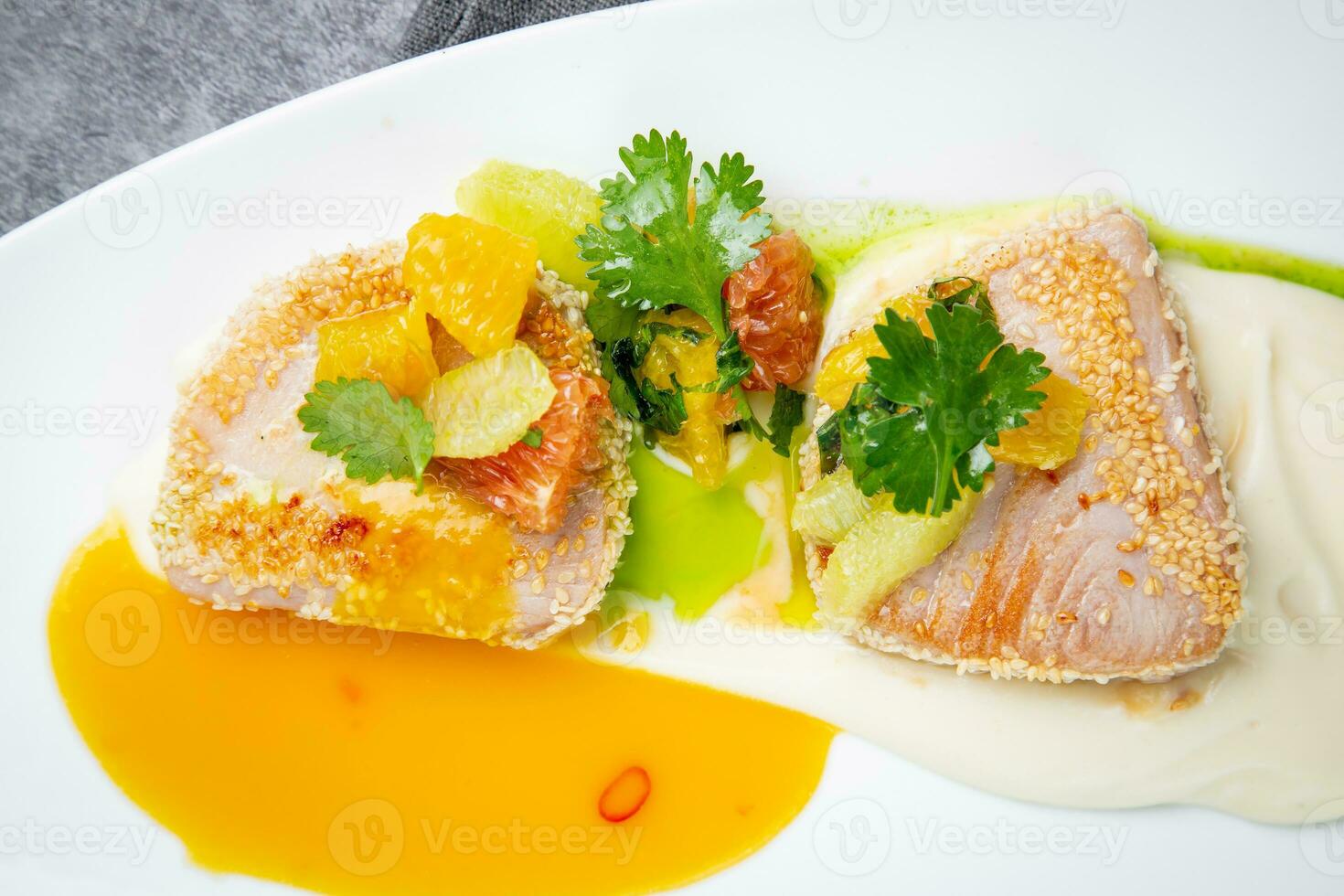 fish with tangerines, parsley and sesame breaded side view photo