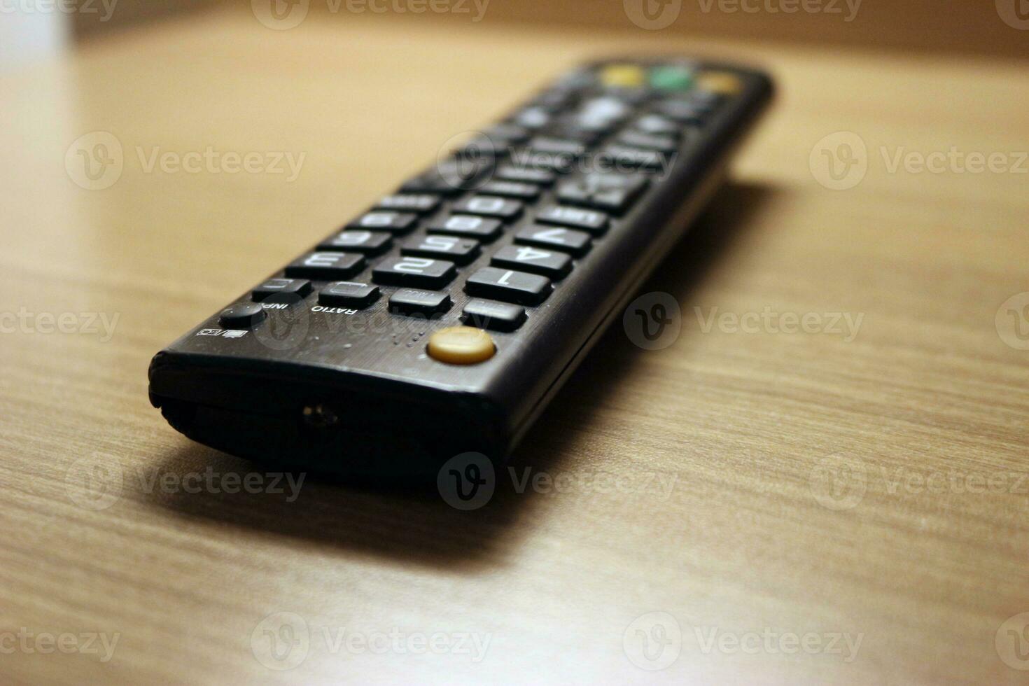 Close up of the television remote on the table photo