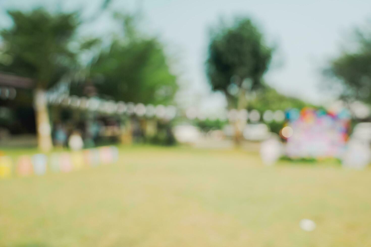 Defocused bokeh and blur background of garden trees in sunlight with vintage toned. photo