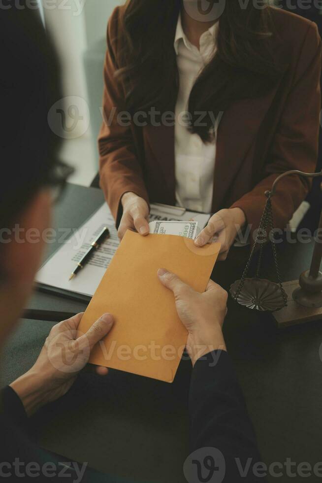 Business and lawyers discussing contract papers with brass scale on desk in office. Law, legal services, advice, justice and law concept picture with film grain effect photo