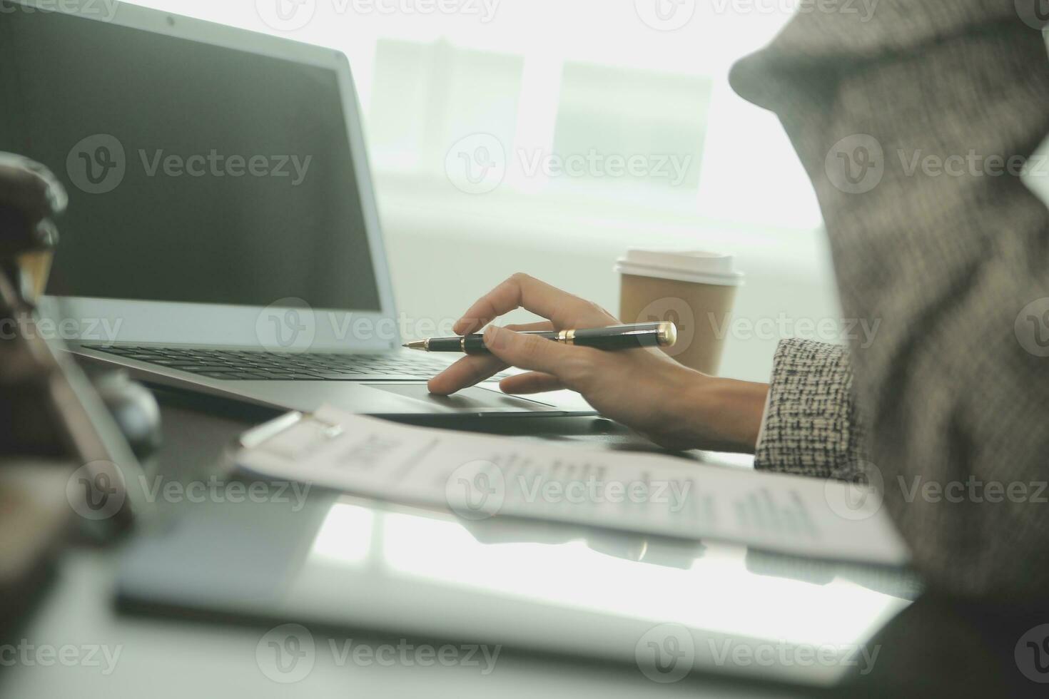 Business and lawyers discussing contract papers with brass scale on desk in office. Law, legal services, advice, justice and law concept picture with film grain effect photo