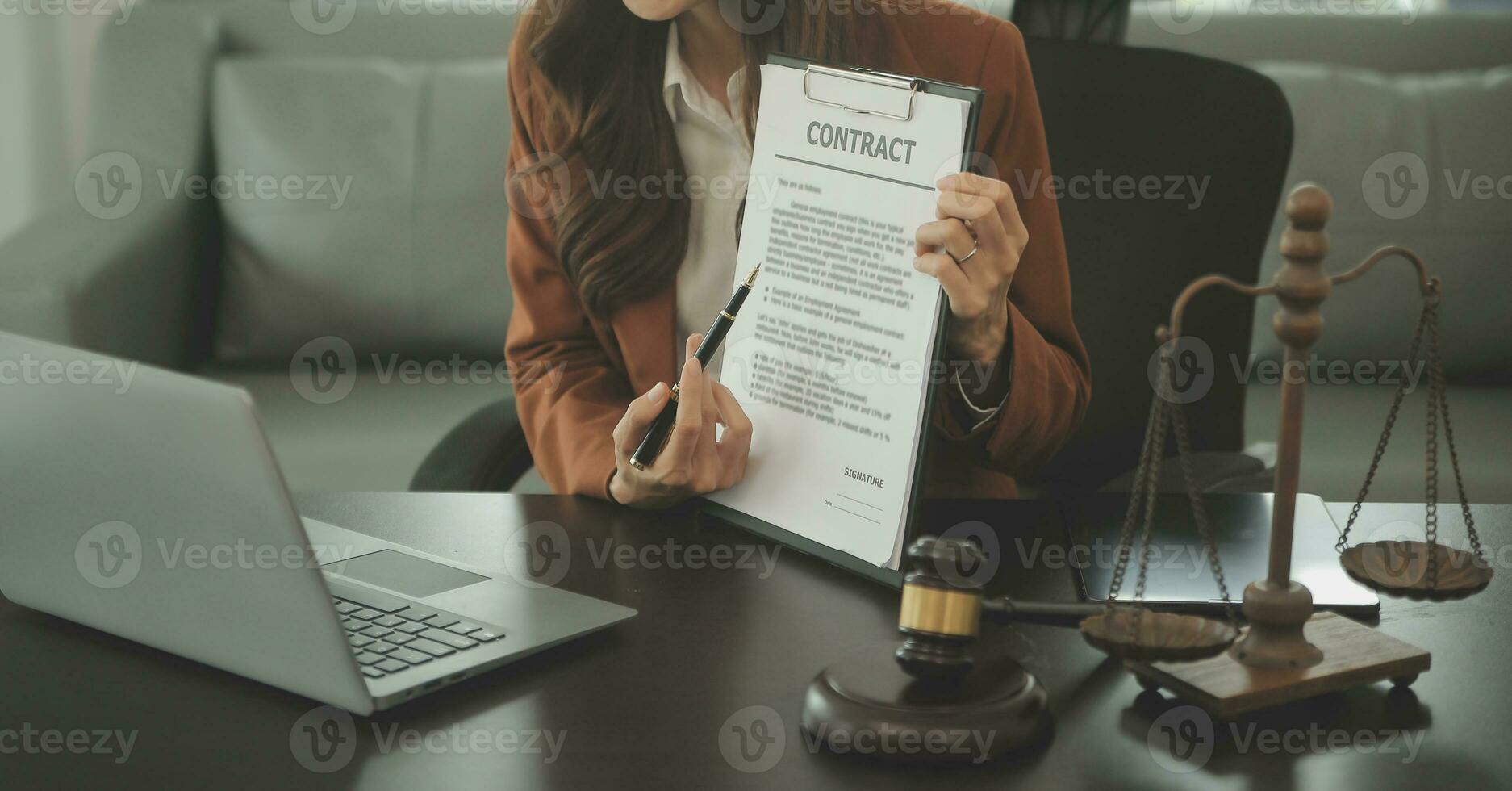 Business and lawyers discussing contract papers with brass scale on desk in office. Law, legal services, advice, justice and law concept picture with film grain effect photo