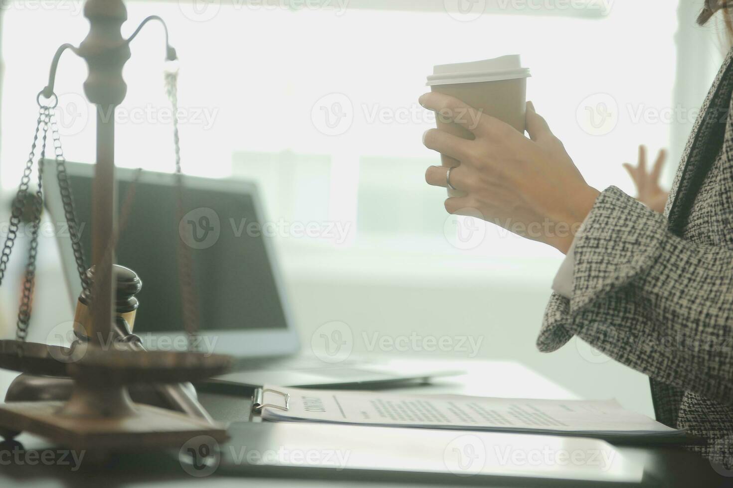 Business and lawyers discussing contract papers with brass scale on desk in office. Law, legal services, advice, justice and law concept picture with film grain effect photo