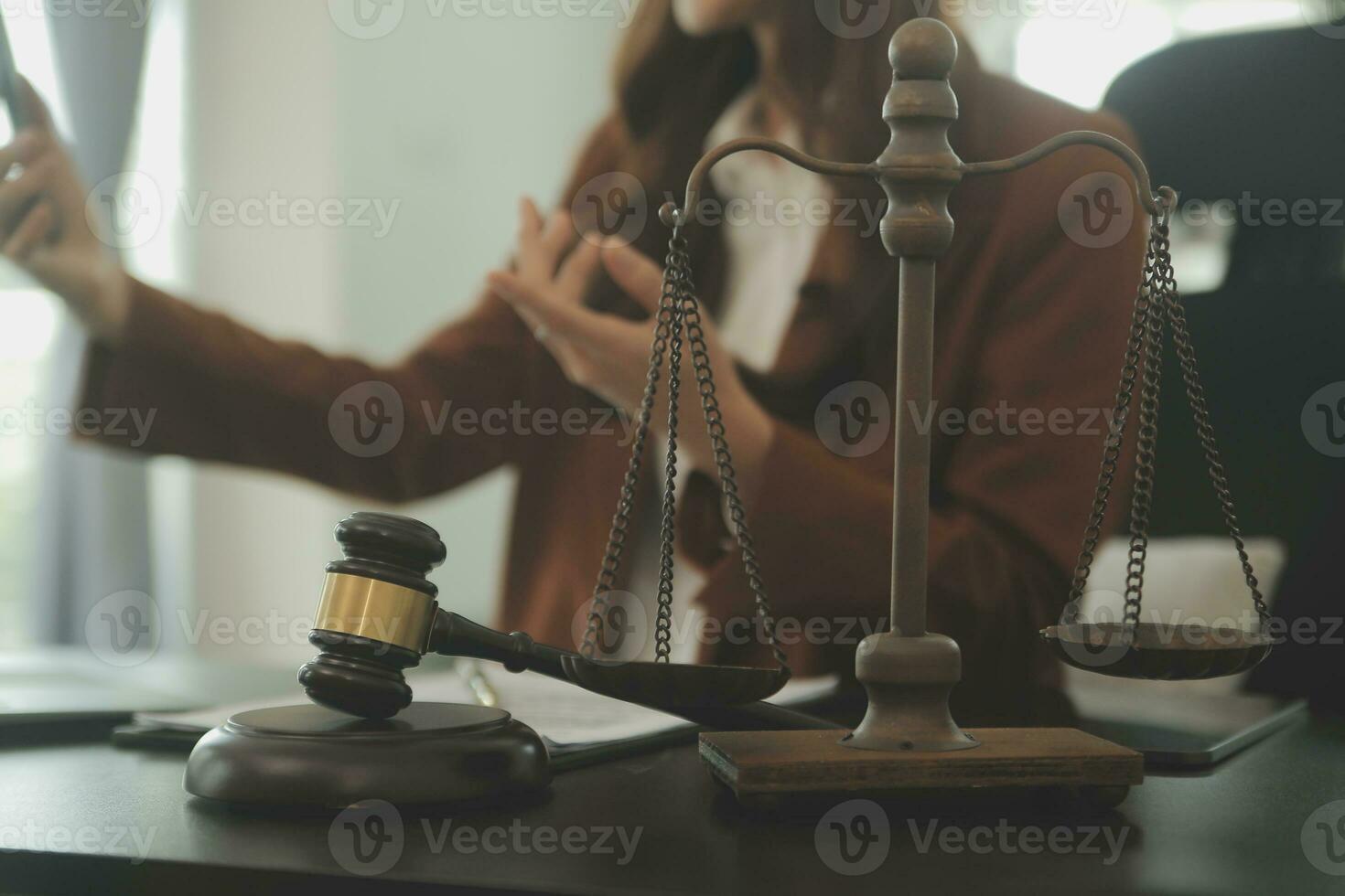 Business and lawyers discussing contract papers with brass scale on desk in office. Law, legal services, advice, justice and law concept picture with film grain effect photo