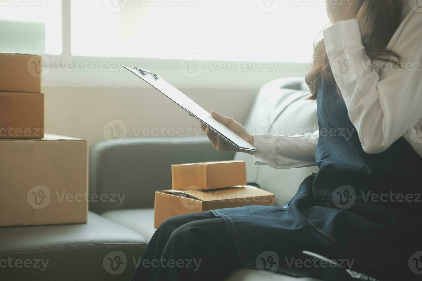 Business woman start up small business entrepreneur SME success .freelance woman working at home with Online Parcel delivery. SME and packaging deliveryconcept photo