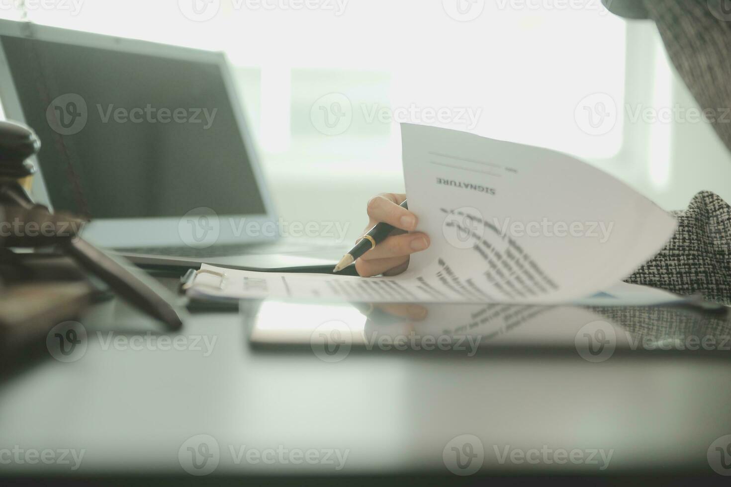 Business and lawyers discussing contract papers with brass scale on desk in office. Law, legal services, advice, justice and law concept picture with film grain effect photo